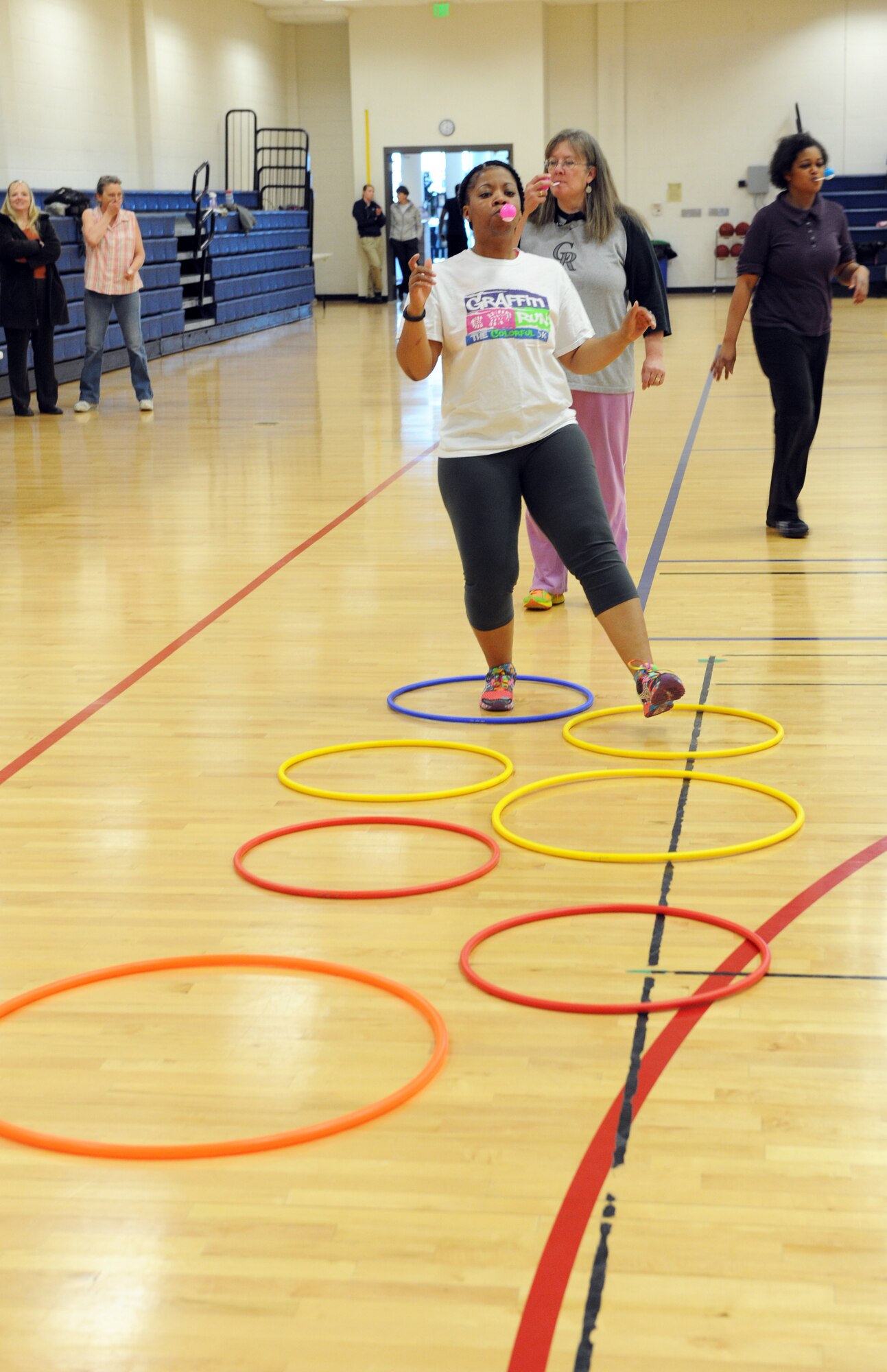 Buckley Total Fitness Challenge participants balance eggs while completing an obstacle course as part of the finale workout of the 10-week challenge April 1, 2014 at the Buckley Fitness Center on Buckley AFB, Colo. The Buckley Fitness Center began the fitness challenge as a way to motivate and promote exercising to Team Buckley members.  (U.S. Air Force photo by Airman Emily E. Amyotte/Released)