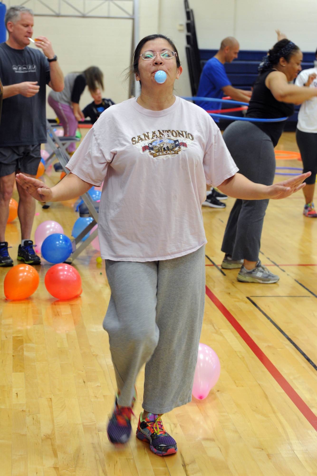 Buckley Total Fitness Challenge participant balances an egg on a spoon while completing a lap around the gym as part of the finale workout of the 10-week challenge April 1, 2014 at the Buckley Fitness Center on Buckley AFB, Colo. The Buckley Fitness Center began the fitness challenge as a way to motivate and promote exercising to Team Buckley members.  (U.S. Air Force photo by Airman Emily E. Amyotte/Released)