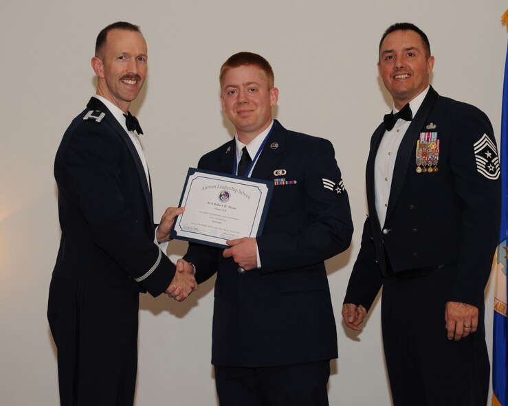 Senior Airman Robert Styza, 189th Operations Support Squadron, Little Rock Air Force Base, Ark., receives an Airman Leadership School graduation certificate from Col. Leland Bohannon, 2nd Bomb Wing vice commander, during the ALS Class 14-3 Graduation on Barksdale AFB, La., March 27, 2014. (U.S. Air Force photo/Senior Airman Benjamin Gonsier)