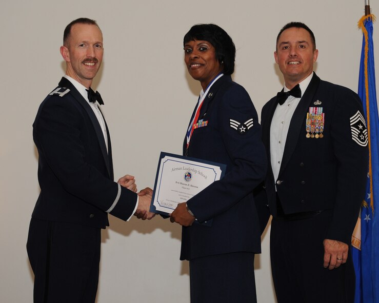 Senior Airman Sharon Stevens, 434th Aerospace Medicine Squadron, Grissom Air Reserve Base, Ind., receives an Airman Leadership School graduation certificate from Col. Leland Bohannon, 2nd Bomb Wing vice commander, during the ALS Class 14-3 Graduation on Barksdale Air Force Base, La., March 27, 2014. (U.S. Air Force photo/Senior Airman Benjamin Gonsier)