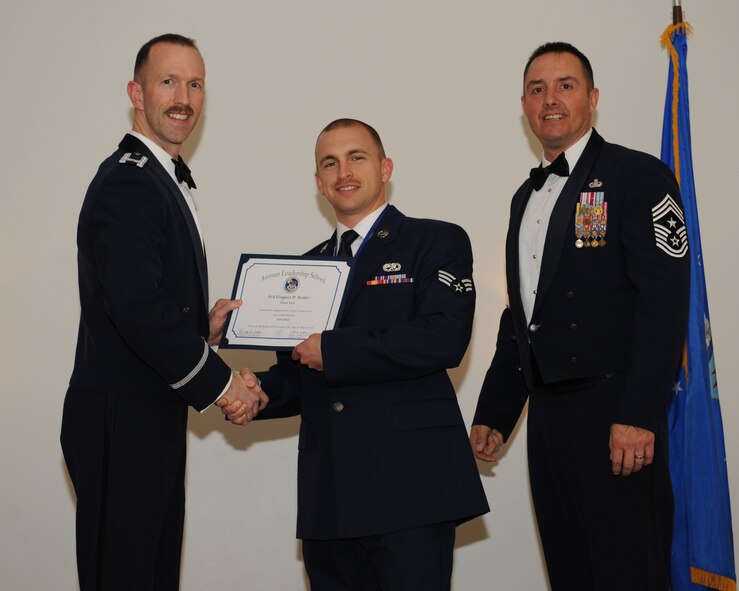 Senior Airman Gregory Seider, 2nd Maintenance Squadron, receives an Airman Leadership School graduation certificate from Col. Leland Bohannon, 2nd Bomb Wing vice commander, during the ALS Class 14-3 Graduation on Barksdale Air Force Base, La., March 27, 2014. (U.S. Air Force photo/Senior Airman Benjamin Gonsier)