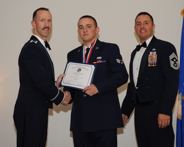 Senior Airman Zachary Reph, 2nd Aircraft Maintenance Squadron, receives an Airman Leadership School graduation certificate from Col. Leland Bohannon, 2nd Bomb Wing vice commander, during the ALS Class 14-3 Graduation on Barksdale Air Force Base, La., March 27, 2014. (U.S. Air Force photo/Senior Airman Benjamin Gonsier)