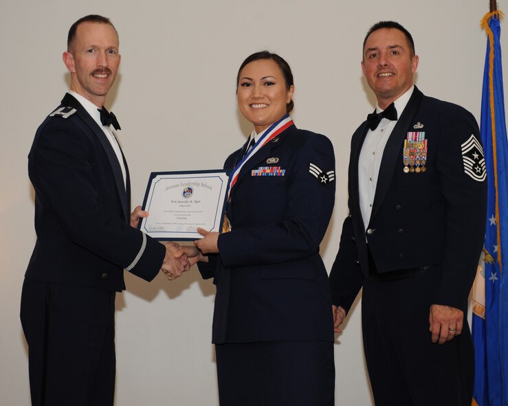 Senior Airman Jennifer Nget, 459th Logistics Readiness Squadron, Joint Base Andrews, Md., receives an Airman Leadership School graduation certificate from Col. Leland Bohannon, 2nd Bomb Wing vice commander, during the ALS Class 14-3 Graduation on Barksdale Air Force Base, La., March 27, 2014. (U.S. Air Force photo/Senior Airman Benjamin Gonsier)