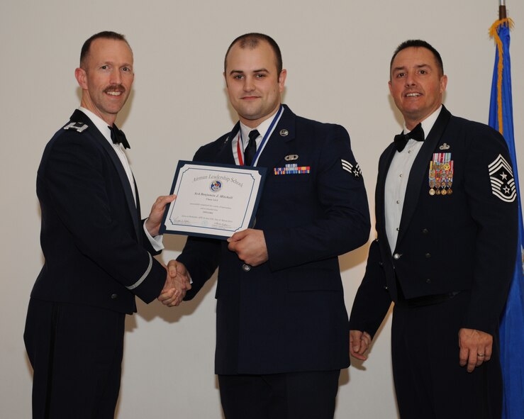Senior Airman Benjamin Mitchell, 2nd Bomb Wing Command Post, receives an Airman Leadership School graduation certificate from Col. Leland Bohannon, 2nd BW vice commander, during the ALS Class 14-3 Graduation on Barksdale Air Force Base, La., March 27, 2014. (U.S. Air Force photo/Senior Airman Benjamin Gonsier)