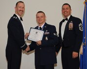 Senior Airman Tyler Hughes, 2nd Security Forces Squadron, receives an Airman Leadership School graduation certificate from Col. Leland Bohannon, 2nd Bomb Wing vice commander, during the ALS Class 14-3 Graduation on Barksdale Air Force Base, La., March 27, 2014. (U.S. Air Force photo/Senior Airman Benjamin Gonsier)