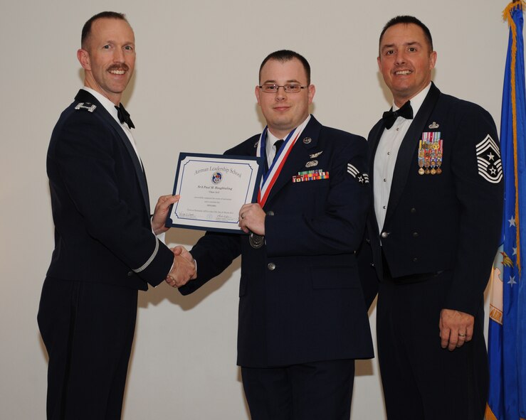 Senior Airman Paul Houghtaling, 916th Maintenance Group, Seymour Johnson Air Force Base, N.C., receives an Airman Leadership School graduation certificate from Col. Leland Bohannon, 2nd Bomb Wing vice commander, during the ALS Class 14-3 Graduation on Barksdale AFB, La., March 27, 2014. (U.S. Air Force photo/Senior Airman Benjamin Gonsier)