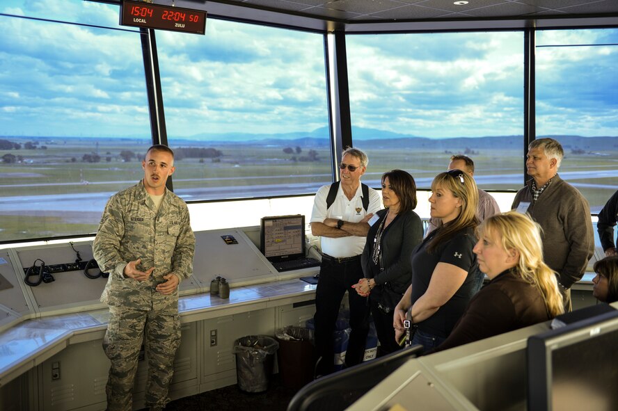 Airman 1st Class Addison Steiger, 60th Operations Support Squadron air traffic controller, explains how controllers monitor aircraft on the radar screen March 28, 2014, to a group of Joint Base Lewis-McChord, Wash., civic leaders during their tour of the control tower at Travis Air Force Base, Calif. The civic leaders toured the air traffic control tower as well as a KC-10 Extender and C-5 Galaxy. (U.S. Air Force photo by Staff Sgt. Russ Jackson)
