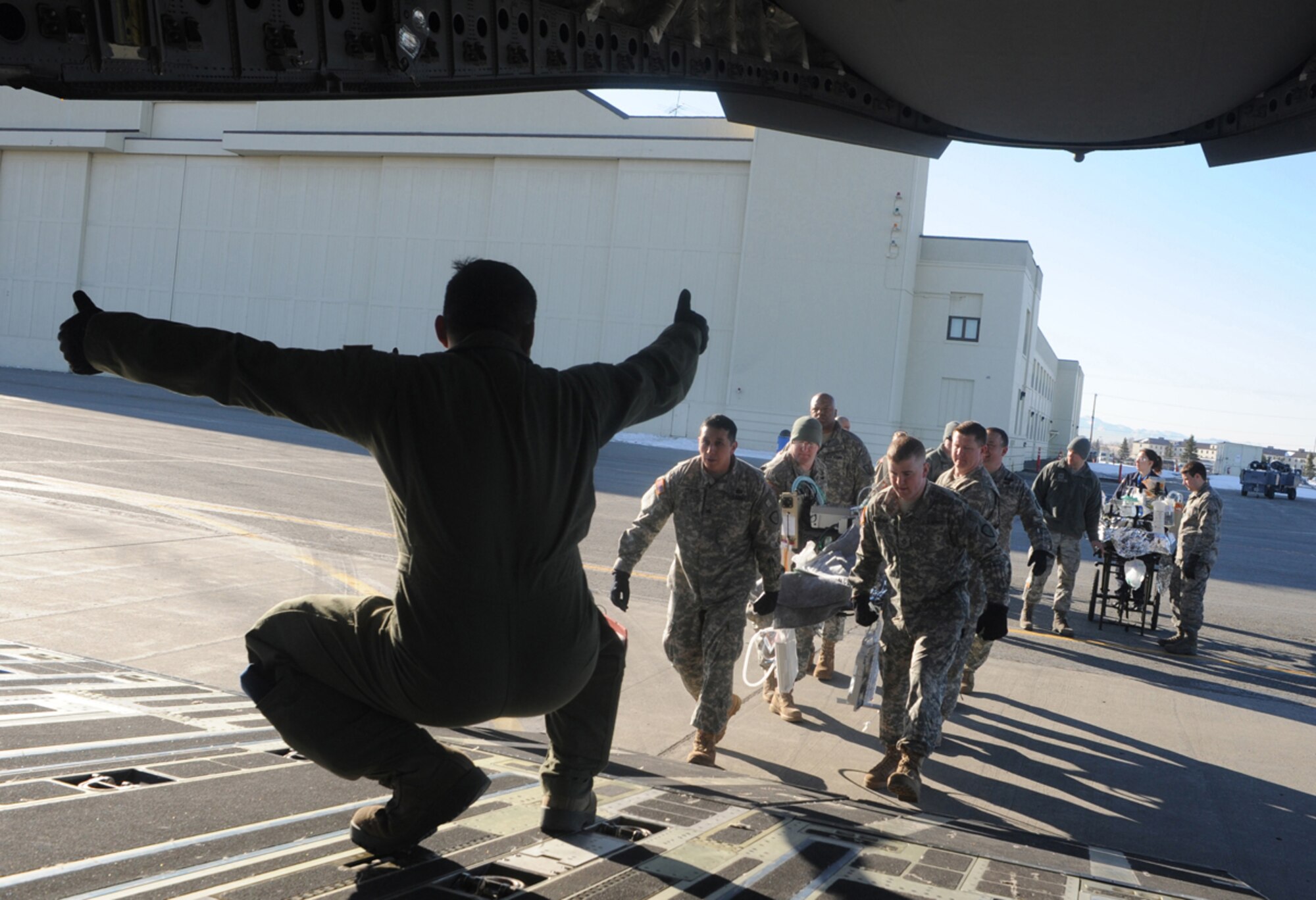 Soldiers load simulated natural disaster casualties onto an Air Force C-17 Globemaster III aircraft during an evacuation drill as part of Mission Assurance Exercise 14-3 at Joint Base Elmendorf-Richardson, Alaska, March 31, 2014. MAE 14-3 is a JBER exercise testing the base’s ability to survive, operate and coordinate during a major natural disaster.   (U.S. Air Force photo/Justin Connaher)
