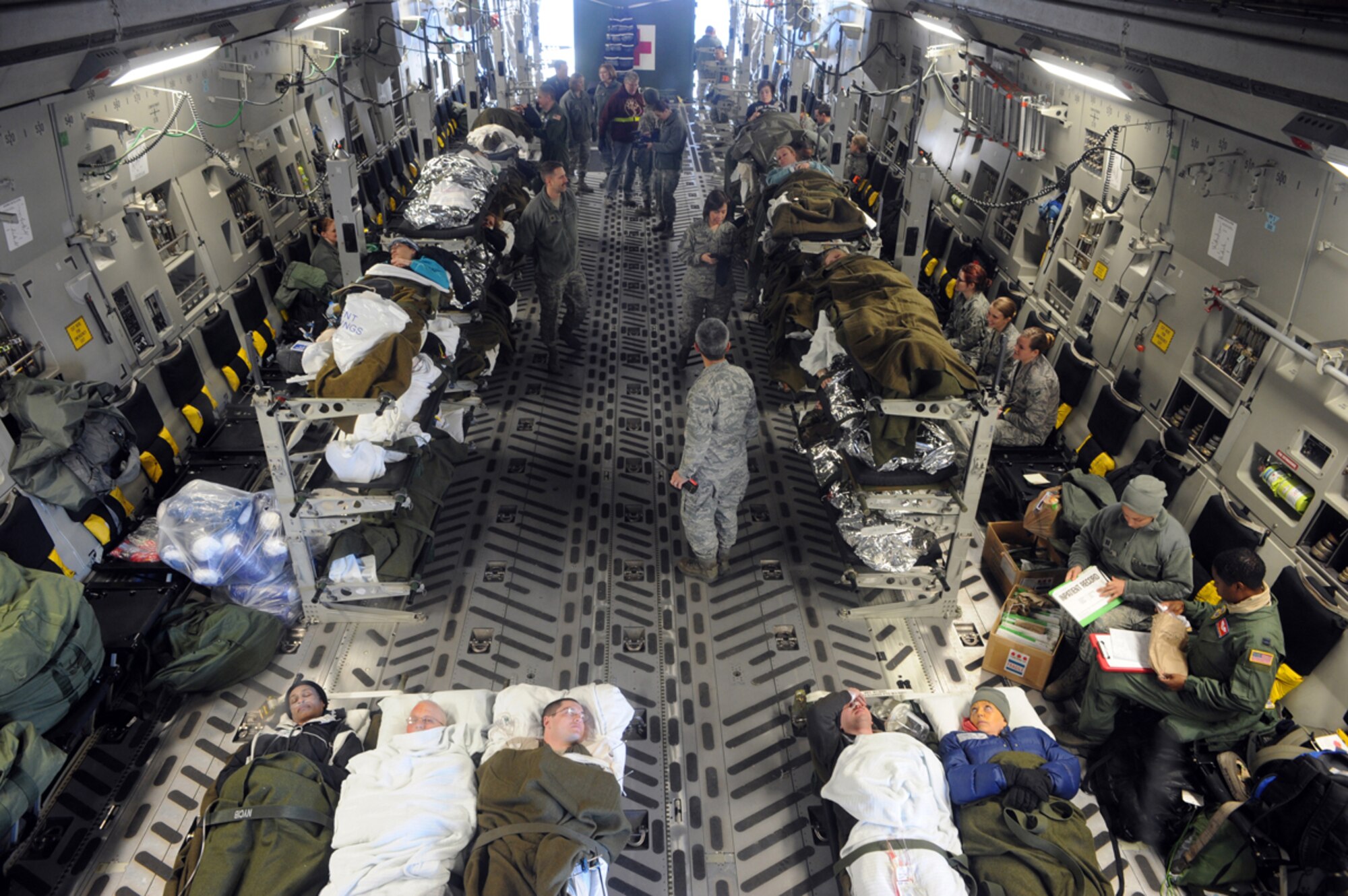 Airmen load simulated natural disaster casualties onto an Air Force C-17 Globemaster III aircraft during an evacuation drill as part of Mission Assurance Exercise 14-3 at Joint Base Elmendorf-Richardson, Alaska, March 31, 2014. MAE 14-3 is a JBER exercise testing the base’s ability to survive, operate and coordinate during a major natural disaster.   (U.S. Air Force photo/Justin Connaher)