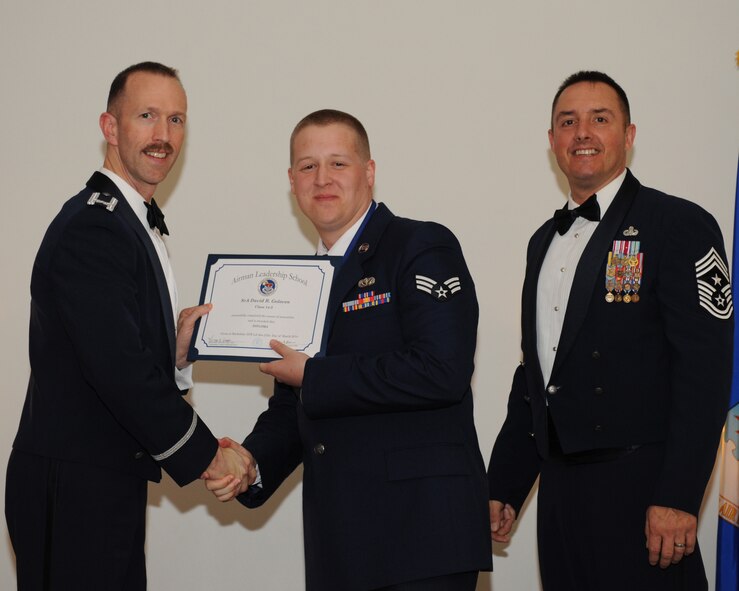 Senior Airman David Goloven, 2nd Force Support Squadron, receives an Airman Leadership School graduation certificate from Col. Leland Bohannon, 2nd Bomb Wing vice commander, during the ALS Class 14-3 Graduation on Barksdale Air Force Base, La., March 27, 2014. (U.S. Air Force photo/Senior Airman Benjamin Gonsier)