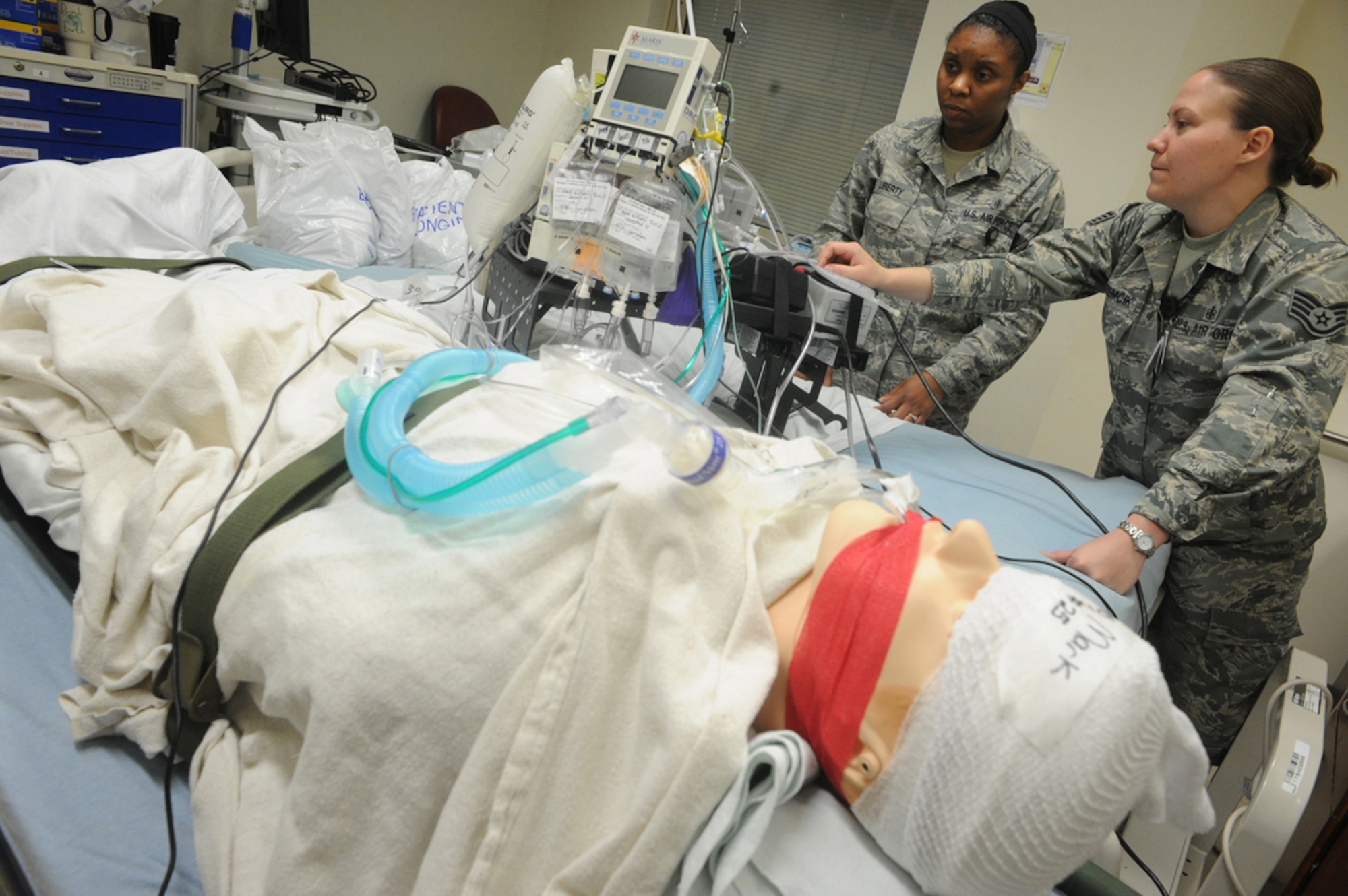 Air Force Staff Sgt. Jasmine Liberty, left, and Staff Sgt. Ashley Zemcik, 673d Medical Group, prepare a simulated natural disaster casualty for transport during an evacuation drill as part of Mission Assurance Exercise 14-3 at Joint Base Elmendorf-Richardson, Alaska, March 31, 2014. MAE 14-3 is a JBER exercise testing the base’s ability to survive, operate and coordinate during a major natural disaster.   (U.S. Air Force photo/Justin Connaher)