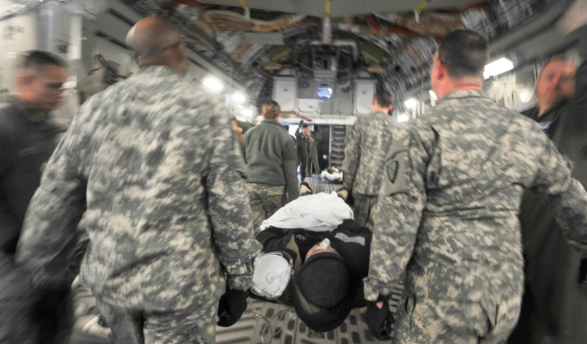Airmen and Soldiers load a simulated natural disaster casualty onto an Air Force C-17 Globemaster III aircraft during an evacuation drill as part of Mission Assurance Exercise 14-3 at Joint Base Elmendorf-Richardson, Alaska, March 31, 2014. MAE 14-3 is a JBER exercise testing the base’s ability to survive, operate and coordinate during a major natural disaster.   (U.S. Air Force photo/Justin Connaher)