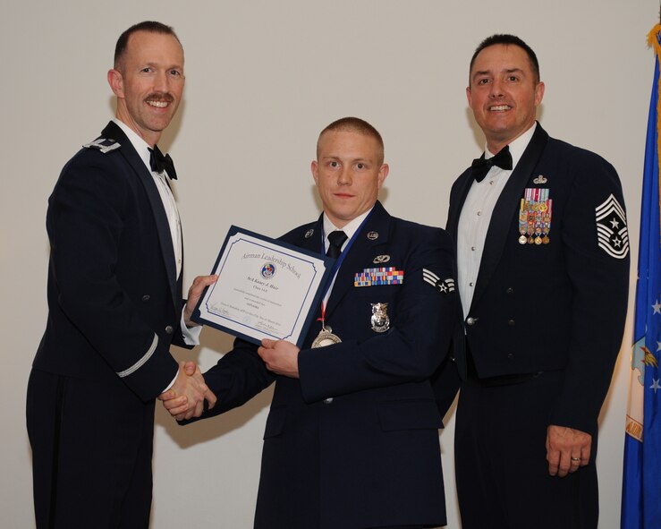 Senior Airman Kasey Hair, 2nd Civil Engineer Squadron, receives an Airman Leadership School graduation certificate from Col. Leland Bohannon, 2nd Bomb Wing vice commander, during the ALS Class 14-3 Graduation on Barksdale Air Force Base, La., March 27, 2014. (U.S. Air Force photo/Senior Airman Benjamin Gonsier)