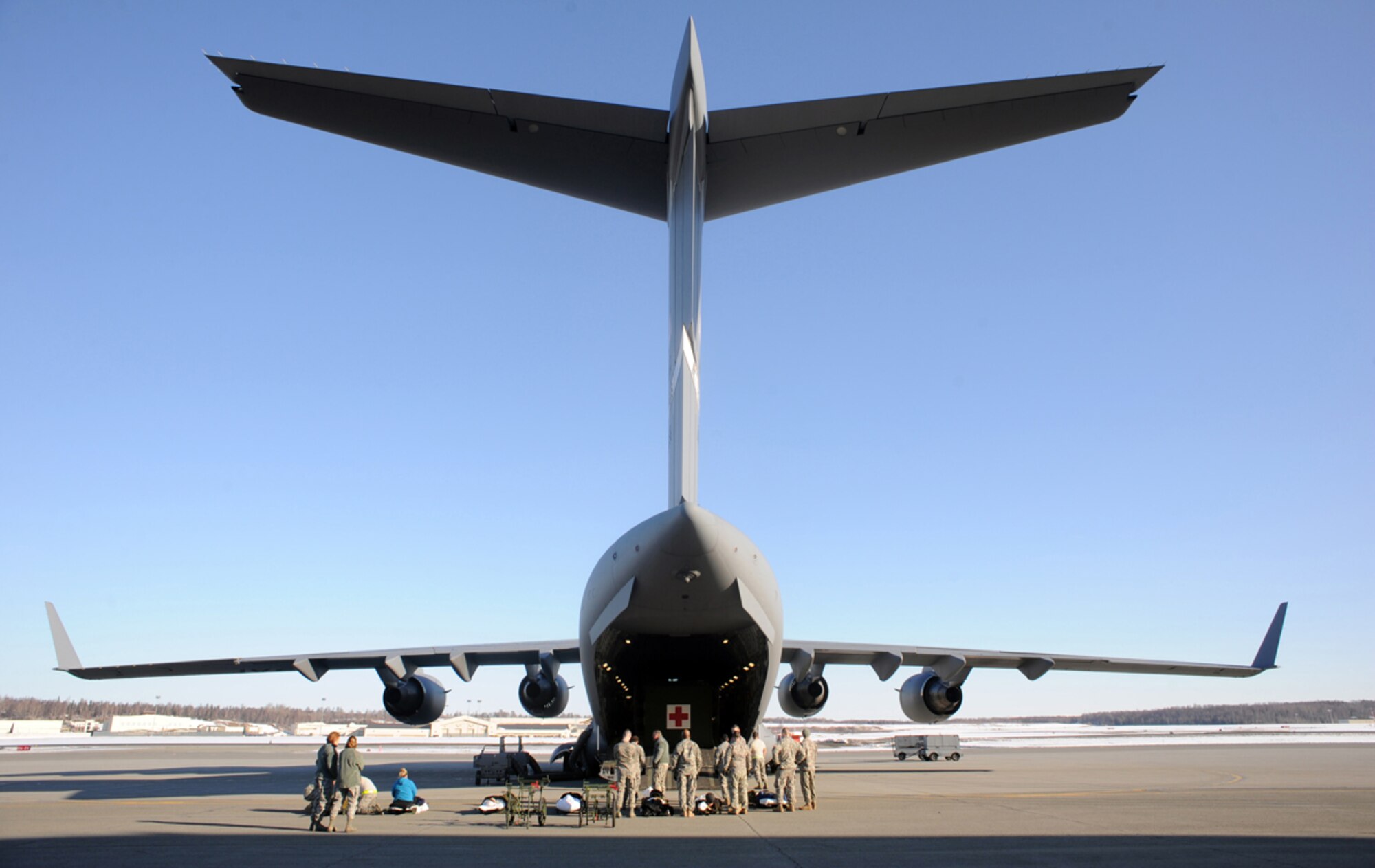 Airmen load simulated natural disaster casualties onto an Air Force C-17 Globemaster III aircraft during an evacuation drill as part of Mission Assurance Exercise 14-3 at Joint Base Elmendorf-Richardson, Alaska, March 31, 2014. MAE 14-3 is a JBER exercise testing the base’s ability to survive, operate and coordinate during a major natural disaster.   (U.S. Air Force photo/Justin Connaher)