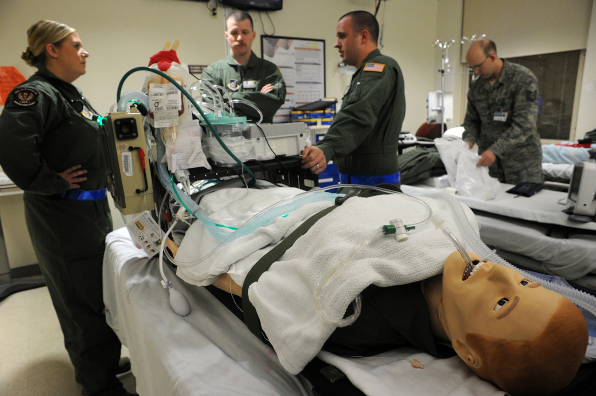 Air Force Capt. Kara Granroth, left, Maj. David Mosteller, and Staff Sgt. Matthew Parker, 673d Medical Group, prepare a simulated natural disaster casualty for transport during an evacuation drill as part of Mission Assurance Exercise 14-3 at Joint Base Elmendorf-Richardson, Alaska, March 31, 2014. MAE 14-3 is a JBER exercise testing the base’s ability to survive, operate and coordinate during a major natural disaster.   (U.S. Air Force photo/Justin Connaher)