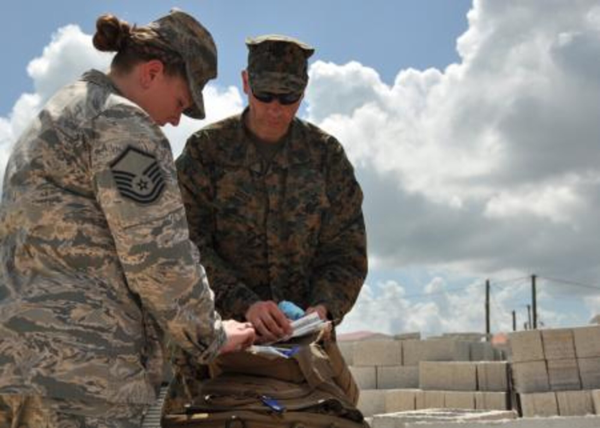 U.S. Air Force Master Sgt. Tara Harrison, independent duty medical technician and New Horizons lead medic for U.S. service members, discusses the availability of medical supplies with U.S Navy Petty Officer 1st Class Tim Greer, a 472nd Marine Wing Support Squadron hospital corpsman, March 31, 2014, at the Edward P. Yorke school construction site in Belize City, Belize. Greer, a six-year corpsman from Shelton, Conn., tasked with providing medical care to U.S. Marines, and Harrison, a 19-year IDMT, discussed supply inventories and medical considerations as they provide care for U.S. service members during New Horizons Belize 2014. (U.S. Air Force photo by Tech. Sgt. Kali L. Gradishar/Released)




