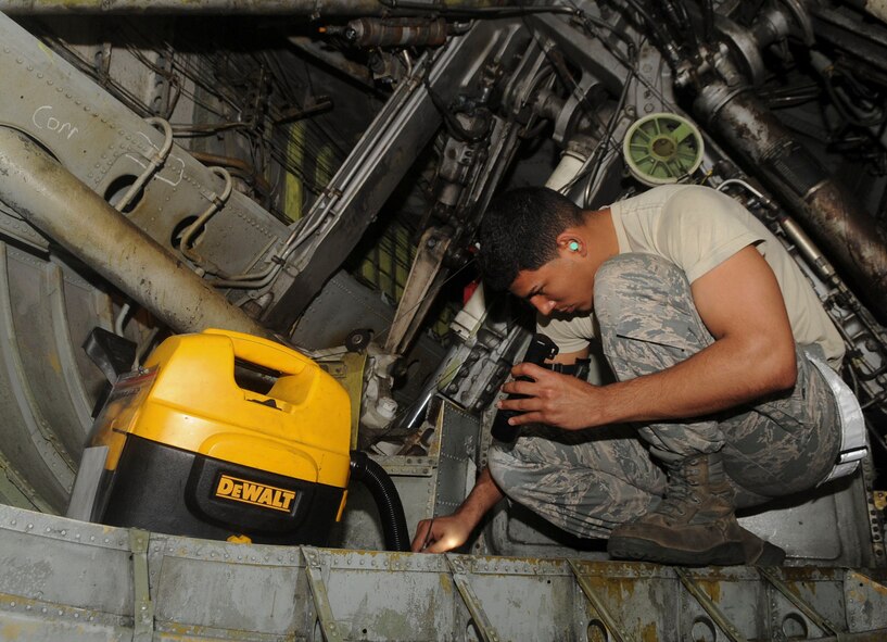 Senior Airman Angel Ducasse, 2nd Maintenance Squadron phase inspection journeyman, inspects and cleans the wheel-well of a B-52H Stratofortress on Barksdale Air Force Base, La., March 31, 2014. The wheel-well collects foreign object debris during take-off and landing and is cleaned out every 450 flying hours to prevent build-up. (U.S. Air Force photo/Senior Airman Kristin High)