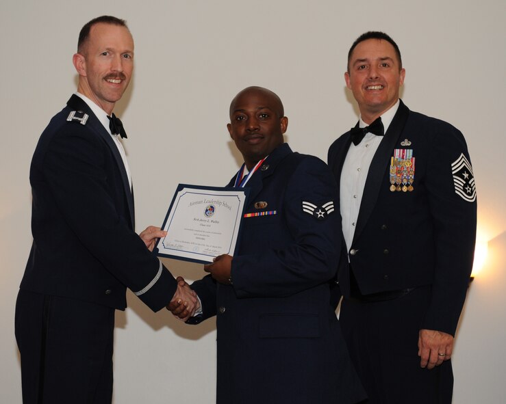 Senior Airman Jerry Walley, 403rd Force Support Squadron, Keesler Air Force Base, Miss., receives an Airman Leadership School graduation certificate from Col. Leland Bohannon, 2nd Bomb Wing vice commander, during the ALS Class 14-3 Graduation on Barksdale AFB, La., March 27, 2014. (U.S. Air Force photo/Senior Airman Benjamin Gonsier)