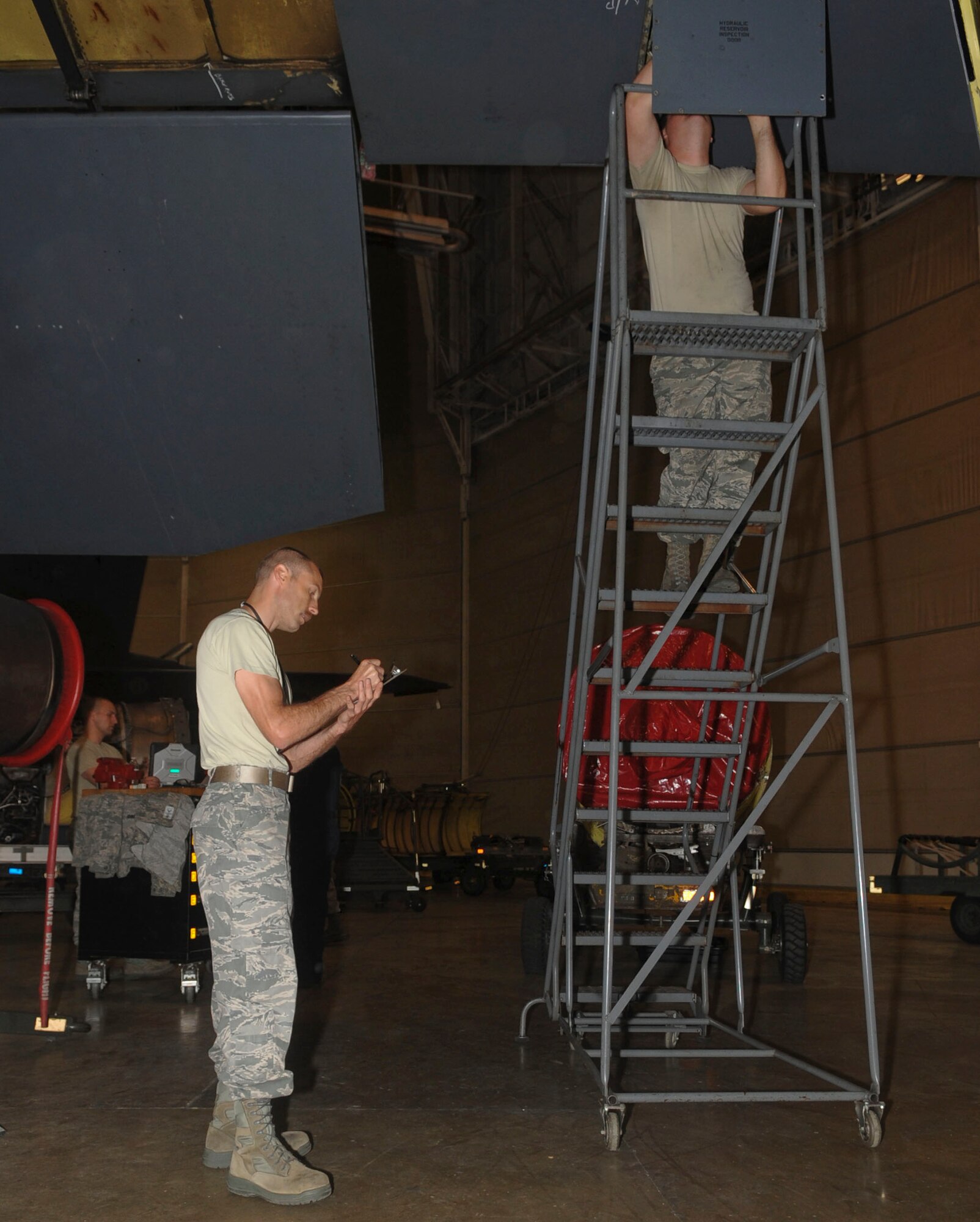Tech. Sgt. Theodore Kolffvanoosterwk, left, and Senior Airman Richard Lester, 2nd Maintenance Squadron aircraft hydraulics technicians, conduct a quality assurance inspection on a B-52H Stratofortress on Barksdale Air Force Base, La., March 31, 2014. After the initial inspection, a second inspection is completed and tasks are assigned for repairs. (U.S. Air Force photo/Senior Airman Kristin High)