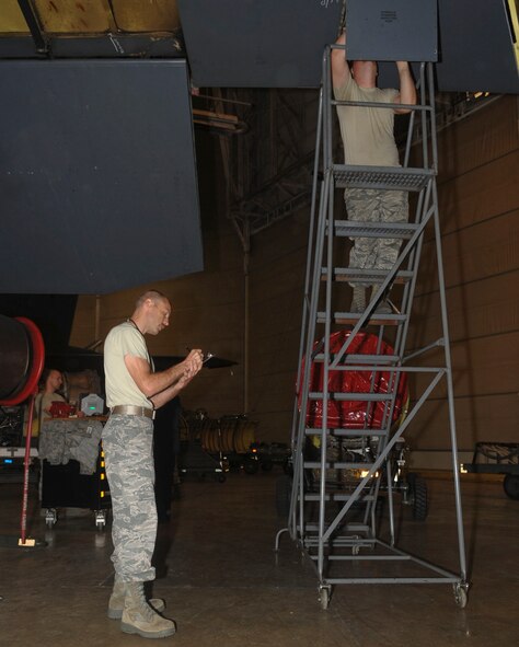 Tech. Sgt. Theodore Kolffvanoosterwk, left, and Senior Airman Richard Lester, 2nd Maintenance Squadron aircraft hydraulics technicians, conduct a quality assurance inspection on a B-52H Stratofortress on Barksdale Air Force Base, La., March 31, 2014. After the initial inspection, a second inspection is completed and tasks are assigned for repairs. (U.S. Air Force photo/Senior Airman Kristin High)