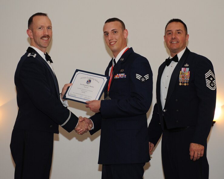 Senior Airman Alexander Rowley, 26th Operational Weather Squadron, receives an Airman Leadership School graduation certificate from Col. Leland Bohannon, 2nd Bomb Wing vice commander, during the ALS Class 14-3 Graduation on Barksdale Air Force Base, La., March 27, 2014. (U.S. Air Force photo/Senior Airman Benjamin Gonsier)