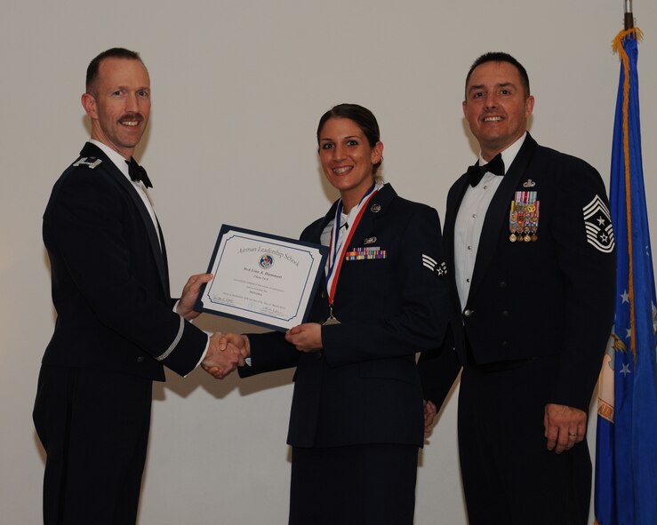 Senior Airman Lisa Hammett, 2nd Logistics Readiness Squadron, receives an Airman Leadership School graduation certificate from Col. Leland Bohannon, 2nd Bomb Wing vice commander, during the ALS Class 14-3 Graduation on Barksdale Air Force Base, La., March 27, 2014. (U.S. Air Force photo/Senior Airman Benjamin Gonsier)