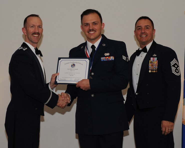 Senior Airman John Gandy, 2nd Communications Squadron, receives an Airman Leadership School graduation certificate from Col. Leland Bohannon, 2nd Bomb Wing vice commander, during the ALS Class 14-3 Graduation on Barksdale Air Force Base, La., March 27, 2014. (U.S. Air Force photo/Senior Airman Benjamin Gonsier)