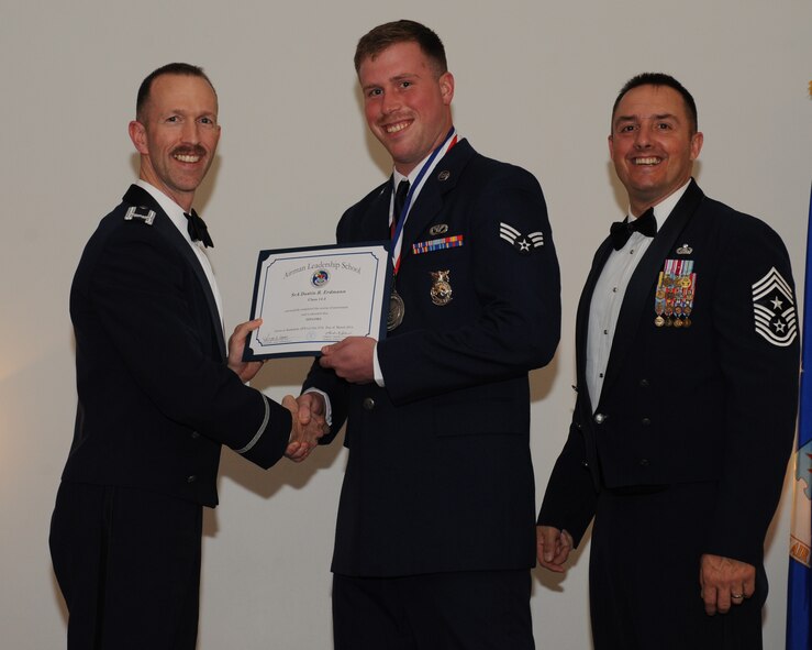 Senior Airman Dustin Erdmann, 2nd Civil Engineer Squadron, receives an Airman Leadership School graduation certificate from Col. Leland Bohannon, 2nd Bomb Wing vice commander, during the ALS Class 14-3 Graduation on Barksdale Air Force Base, La., March 27, 2014. (U.S. Air Force photo/Senior Airman Benjamin Gonsier)