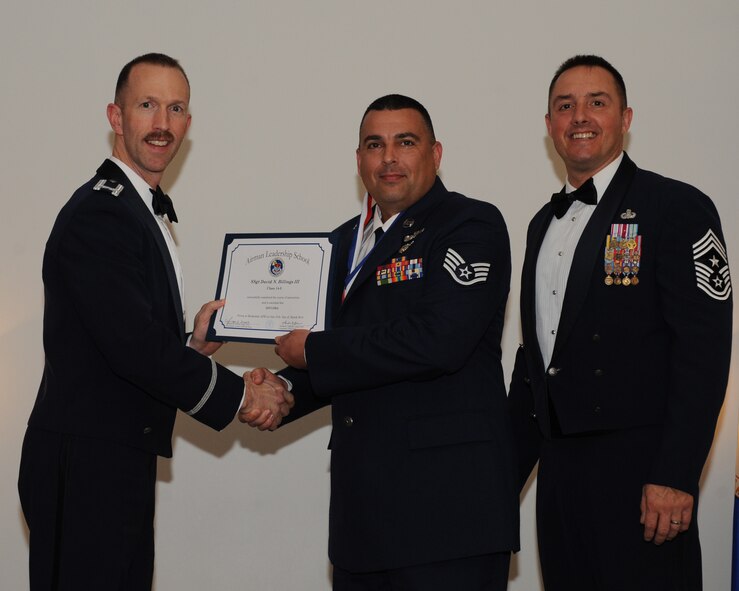 Staff Sgt. David Billings, 154th Training Squadron, Little Rock Air Force Base, Ark., receives an Airman Leadership School graduation certificate from Col. Leland Bohannon, 2nd Bomb Wing vice commander, during the ALS Class 14-3 Graduation on Barksdale Base, La., March 27, 2014. (U.S. Air Force photo/Senior Airman Benjamin Gonsier)