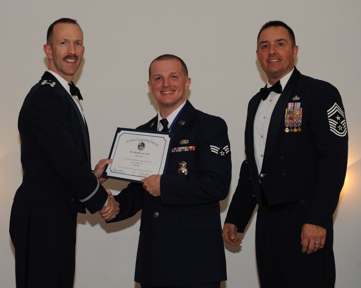 Senior Airman Michael Wise, 2nd Security Forces Squadron, receives an Airman Leadership School graduation certificate from Col. Leland Bohannon, 2nd Bomb Wing vice commander, during the ALS Class 14-3 Graduation on Barksdale Air Force Base, La., March 27, 2014. (U.S. Air Force photo/Senior Airman Benjamin Gonsier)