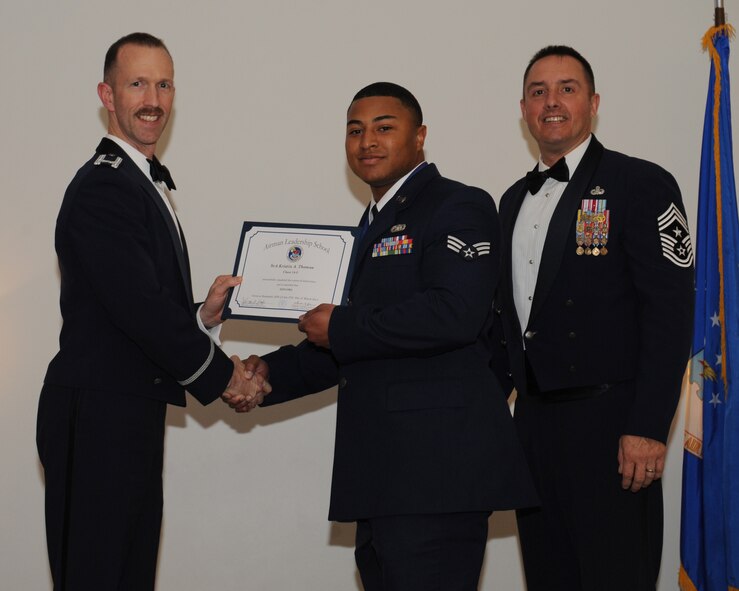 Senior Airman Kristin Thomas, 2nd Logistics Readiness Squadron, receives an Airman Leadership School graduation certificate from Col. Leland Bohannon, 2nd Bomb Wing vice commander, during the ALS Class 14-3 Graduation on Barksdale Air Force Base, La., March 27, 2014. (U.S. Air Force photo/Senior Airman Benjamin Gonsier)