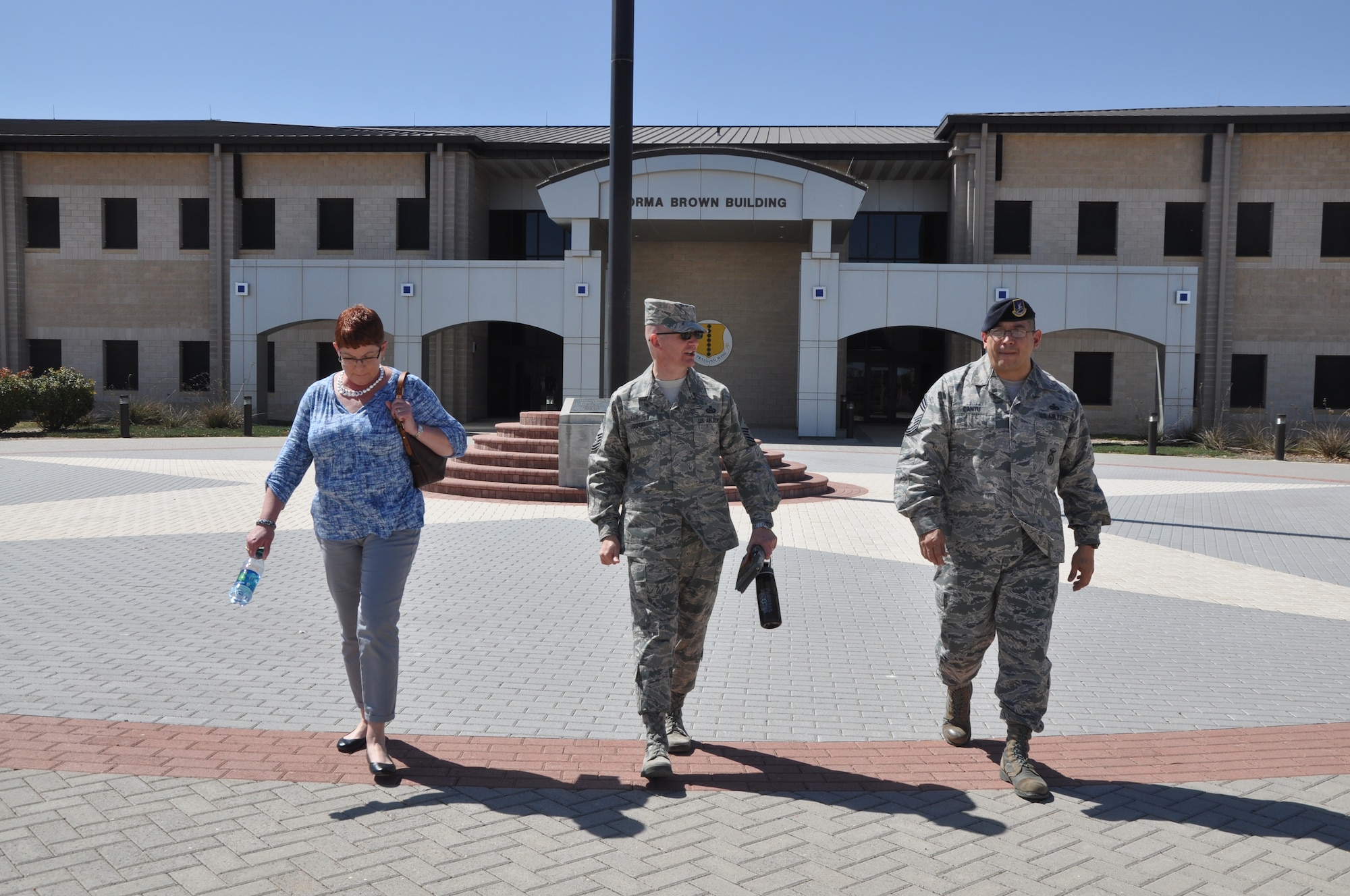 GOODFELLOW AIR FORCE BASE, Texas -- Tennie Good, family member, Chief Master Sgt. Thomas F. Good, 17th Training Wing command chief, and Chief Master Sgt. Jessie Cantu, 17th Security Forces Squadron security forces manager, walk to the 17th SFS building here March 18. Good conducted several emersions within the 17th TRW to meet and greet service members.  (U.S. Air Force photo/ Airman 1st Class Breonna Veal)