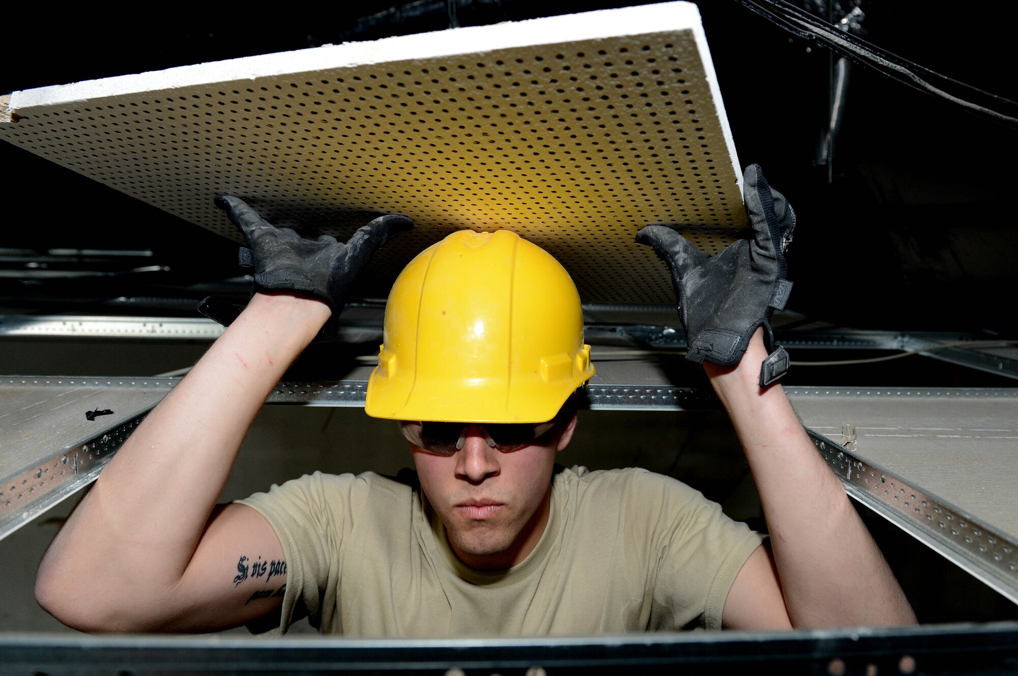 U.S. Air Force Senior Airman Corey Meisel, 52nd Civil Engineer Squadron structures shop from Lakeland, Fla., removes ceiling tiles for a renovation at Spangdahlem Air Base, Germany, April 1, 2014. The renovation provided the furnishings management office with more than 25,000 square feet of storage space. The office provides temporary housing supplies for Airmen who reside on and off-base. (U.S. Air Force photo by Airman 1st Class Kyle Gese/Released)