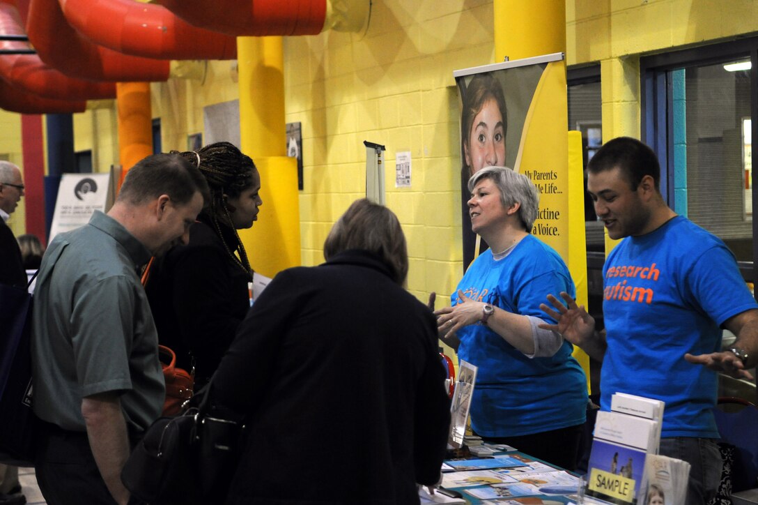 Attendees of the Exceptional Family Member Program Resource Fair and Conference seek information from the Benedictine School at the Youth Center on Joint Base Andrews, Md., March 29, 2014. The Benedictine School has educational, residential and day services for children and adults with developmental disabilities. (U.S. Air Force photo/Airman 1st Class Ryan J. Sonnier)