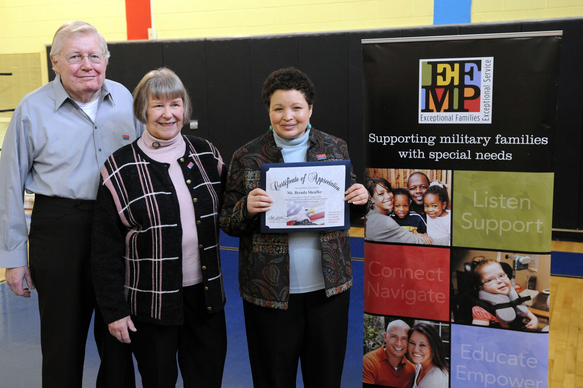 Brenda Sheaffer stands with her parents after receiving an award for her support of the Joint Services Exceptional Family Member Program Resource Fair and Conference held at the Youth Center on Joint Base Andrews, Md., March 29, 2014. Sheaffer has a learning disability, but doesn’t let that stop her. She is currently working at the White House Complex and has been featured in the Washington Post. (U.S. Air Force photo/Airman 1st Class Ryan J. Sonnier)