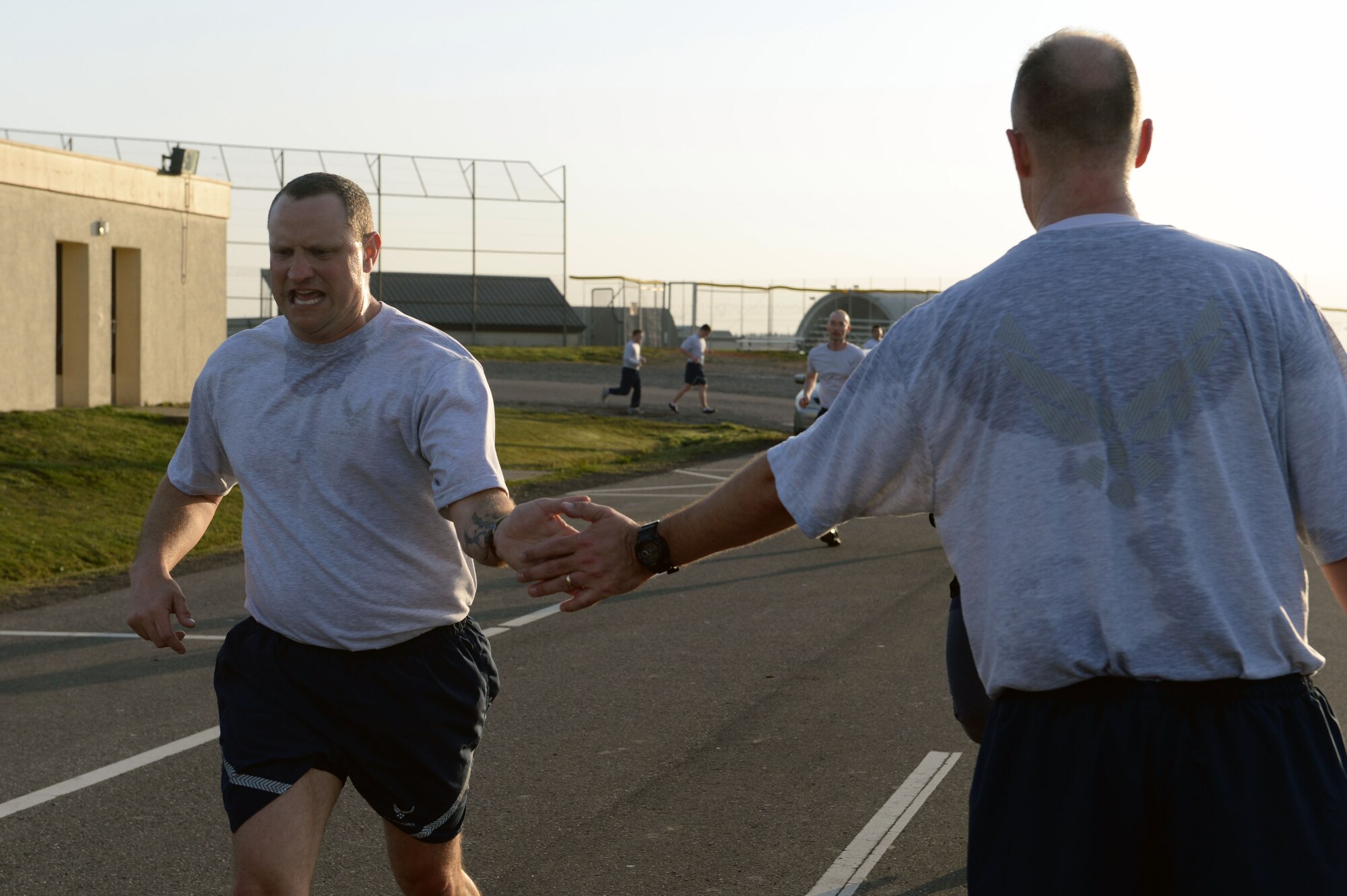 An Airman encourages his peer during a wing-wide 5K fun run for Sexual Assault Awareness Month at Spangdahlem Air Base, Germany, April 2, 2014. Event coordinators invited all base members to participate in the free event to raise awareness on sexual assault. (U.S. Air Force photo by Senior Airman Alexis Siekert/Released)
