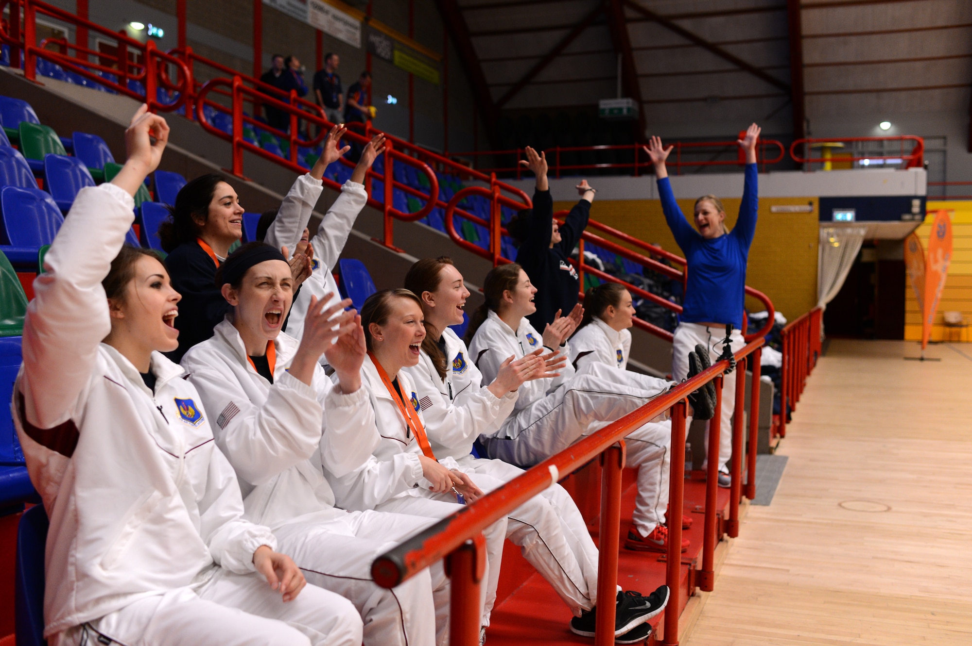 Members of the U.S. Air Forces in Europe and Air Forces Africa women’s volleyball team cheer for the men’s team during a Headquarters Allied Air Command Inter-Nation Sports Programme Volleyball Championship match in Amsterdam, March 27, 2014. The women’s team has placed first in six of the last six championships they have participated in including this year’s tournament. (U.S. Air Force photo by Senior Airman Gustavo Castillo/Released)