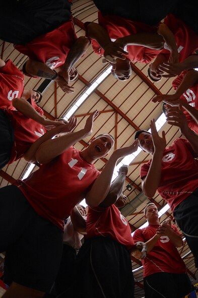 Members of the U.S. Air Forces in Europe and Air Forces Africa men's volleyball team huddle up before a Headquarters Allied Air Command Inter-Nation Sports Programme Volleyball Championship match in Amsterdam, March 27, 2014. The men’s team finished the tournament in third place out of the six countries representing their respective air force. (U.S. Air Force photo by Senior Airman Gustavo Castillo/Released)