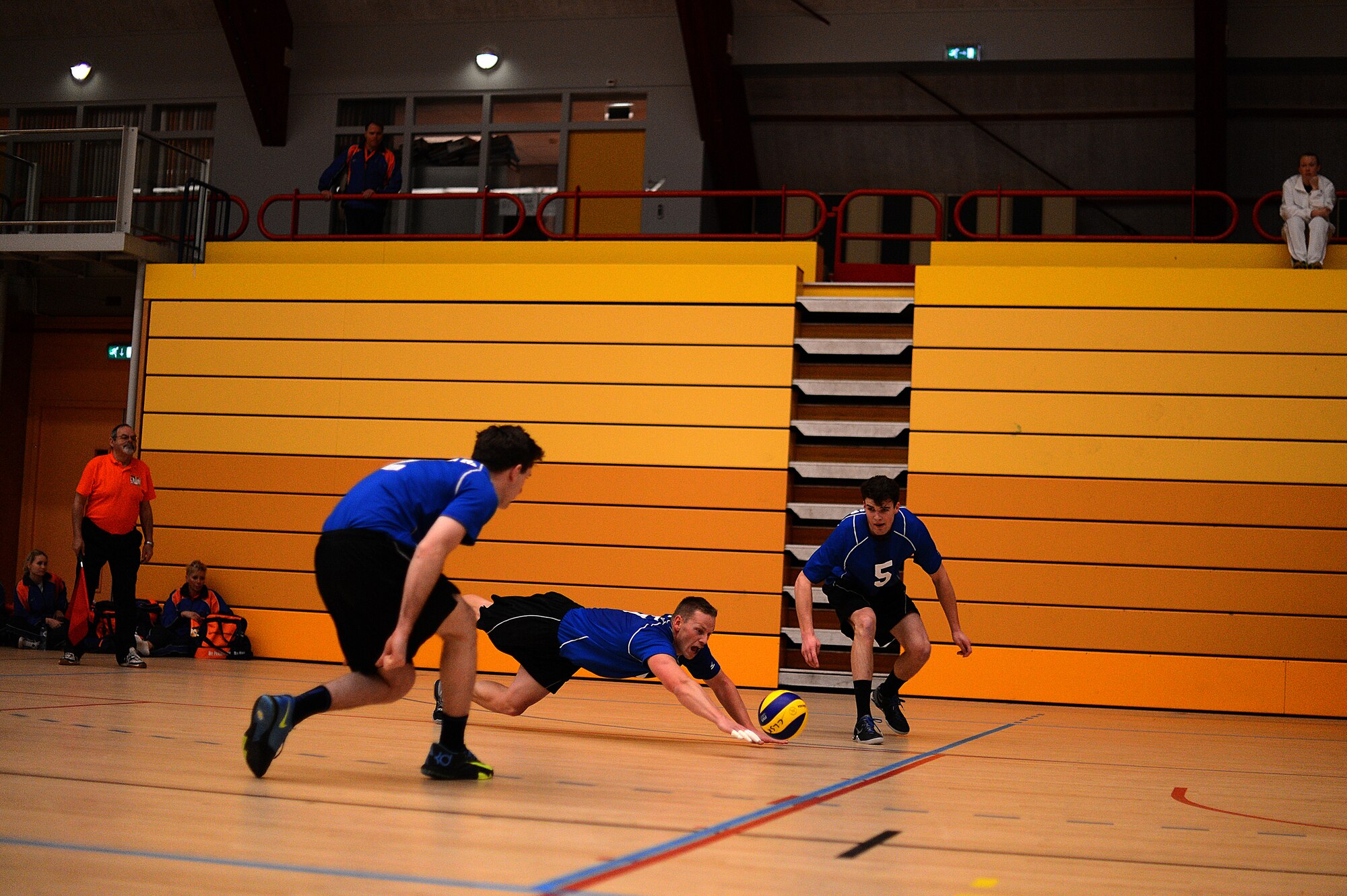 Stuart Sherman, U.S. Air Forces in Europe and Air Forces Africa men’s volleyball team outside hitter from Tuscon, Ariz., center, dives for the ball during a Headquarters Allied Air Command Inter-Nation Sports Programme Volleyball Championship match in Amsterdam, March 26, 2014. Sherman received the outstanding sportsmanship award for his actions displayed during the tournament. (U.S. Air Force photo by Senior Airman Gustavo Castillo/Released)