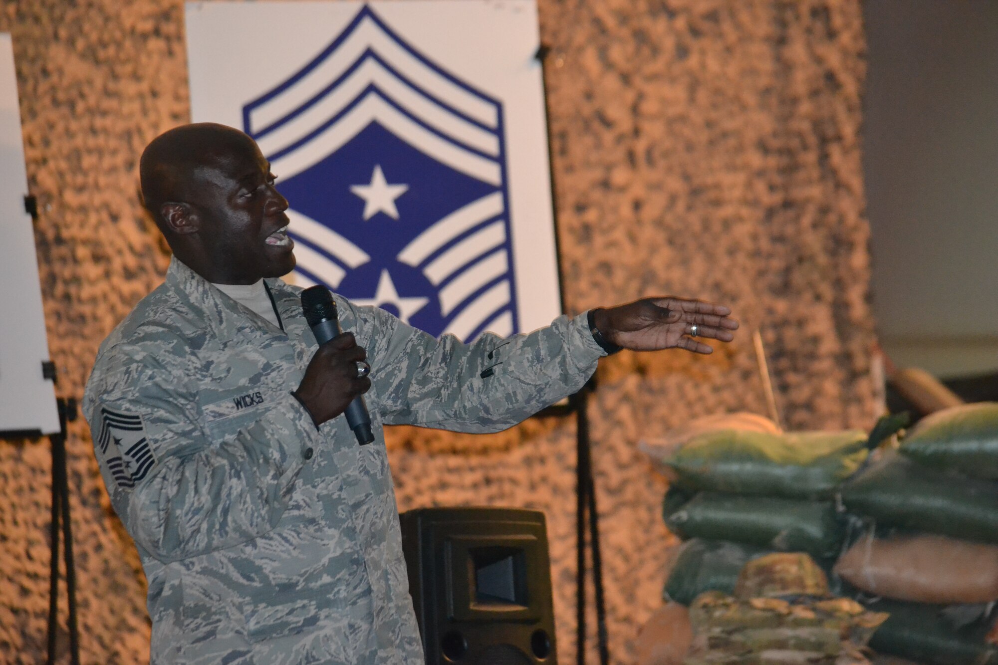 Chief Master Sgt. Rory Wicks, 379th Air Expeditionary Wing command chief, thanks Airmen for celebrating his 30 years of service in the Air Force, Mar. 28, 2014, Al Udeid Air Base, Qatar.  Service members and civilians gathered to host a barbeque in his honor where he was presented with several tokens of appreciation and gifts from various professional and private organizations on base, a tribute the impact he has had on so many lives.   Wicks, best known for his energetic “HUA,” will have his official retirement ceremony upon his return to Luke Air Force Base, Ariz. in April.  (U.S. Air Force photo/Maj. Nicole David)