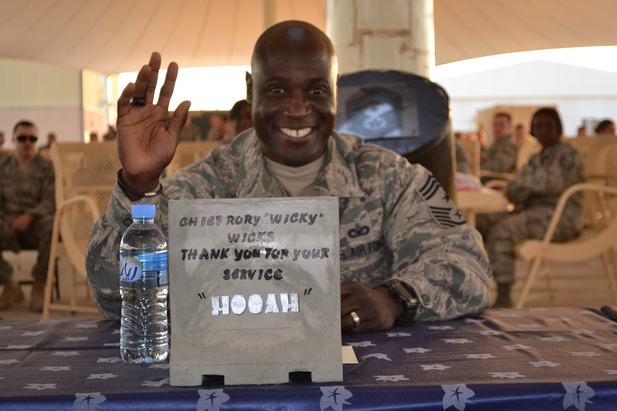 Chief Master Sgt. Rory Wicks, 379th Air Expeditionary Wing command chief, is celebrated for his 30 years of service in the Air Force on Mar. 28, 2014, Al Udeid Air Base, Qatar.  Service members and civilians gathered to host a barbeque in his honor where he was presented with several tokens of appreciation and gifts from various professional and private organizations on base, a tribute the impact he has had on so many lives.   Wicks, best known for his energetic “HUA,” will have his official retirement ceremony upon his return to Luke Air Force Base, Ariz. this month.  (U.S. Air Force photo/Maj. Nicole David)