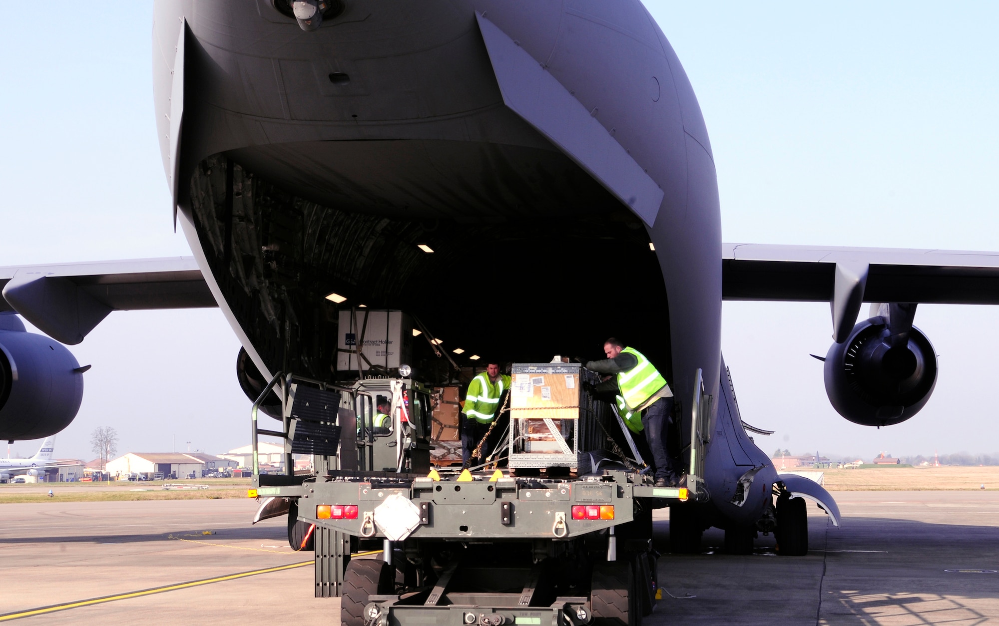 Freight handlers from the 727th Air Mobility Squadron move a crated KC-135 Stratoanker boom from a C-17 Globemaster III onto a 25 K-loader March 12, 2014, on RAF Mildenhall, England. Ministry of Defence workers and Airmen from the 727th AMS regularly unload and upload cargo from incoming and onto outgoing aircraft every week. During 2013, the 727th AMS Air Freight section handled 3,900 tons of cargo from 3,800 aircraft missions. (U.S. Air Force photo by Karen Abeyasekere/Released)