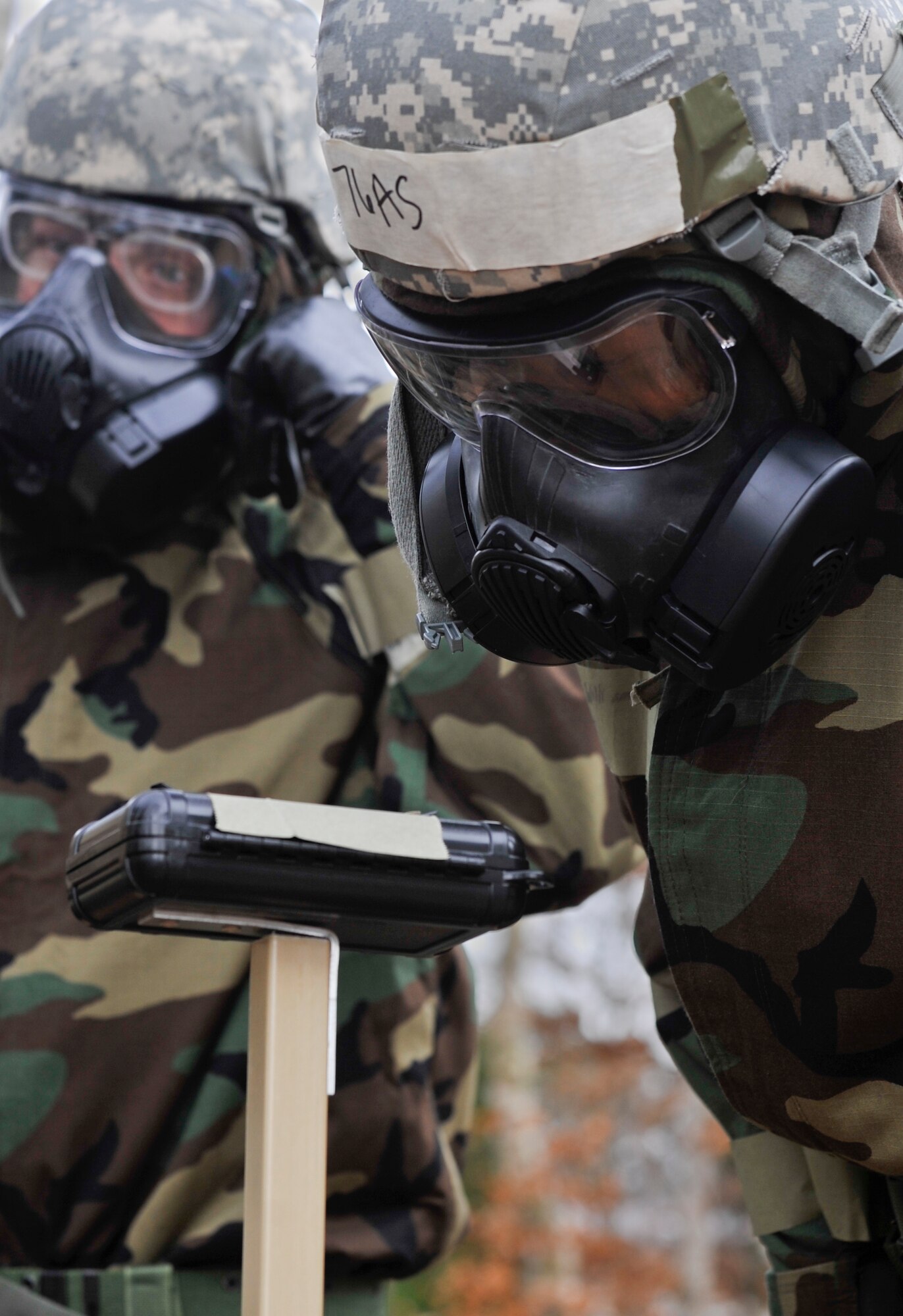 Master Sgt. Toby Stolz, 603rd Air and Space Operations Center superintendent, checks an M8 paper for aerial chemicals during a simulated post-attack reconnaissance sweep March 3, 2014 at Ramstein Air Base, Germany. The chemical, biological, radiological and nuclear class refreshes Airmen’s training on how to handle a CBRN situation. (U.S. Air Force photo/Airman Larissa Greatwood)