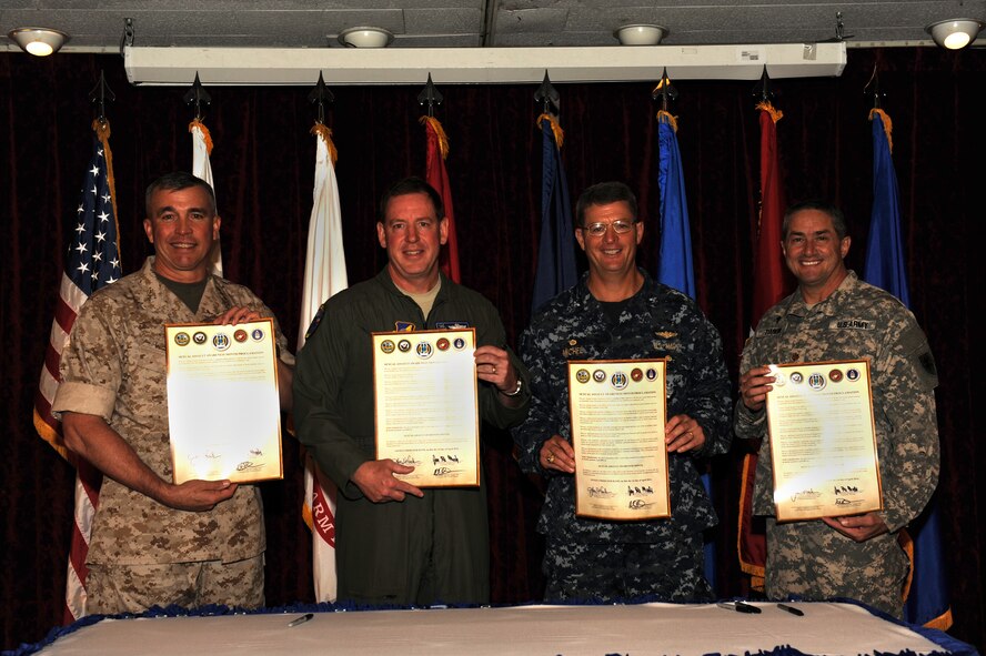 From left to right: U.S. Marine Corps Lt. Gen. John E. Wissler, 3rd Marine Expeditionary Force commanding general and Marine Forces Japan commander; U.S. Air Force Brig. Gen. James B. Hecker, 18th Wing commander; U.S. Navy Capt. Michael D. Michel, commanding officer of fleet activities, Okinawa; and U.S. Army Maj. Myron Temkin, 10th Regional Support Group chaplain; pose for a photo after signing a proclamation to show their support of the Sexual Assault Prevention and Response mission at the Rocker NCO Club on Kadena Air Base, Japan, April 1, 2014. The proclamation officially declared April 2014 as Sexual Assault Awareness Month, and outlined what the SAPR program is and what it looks for.  (U.S. Air Force photo by Airman 1st Class Zackary Henry)