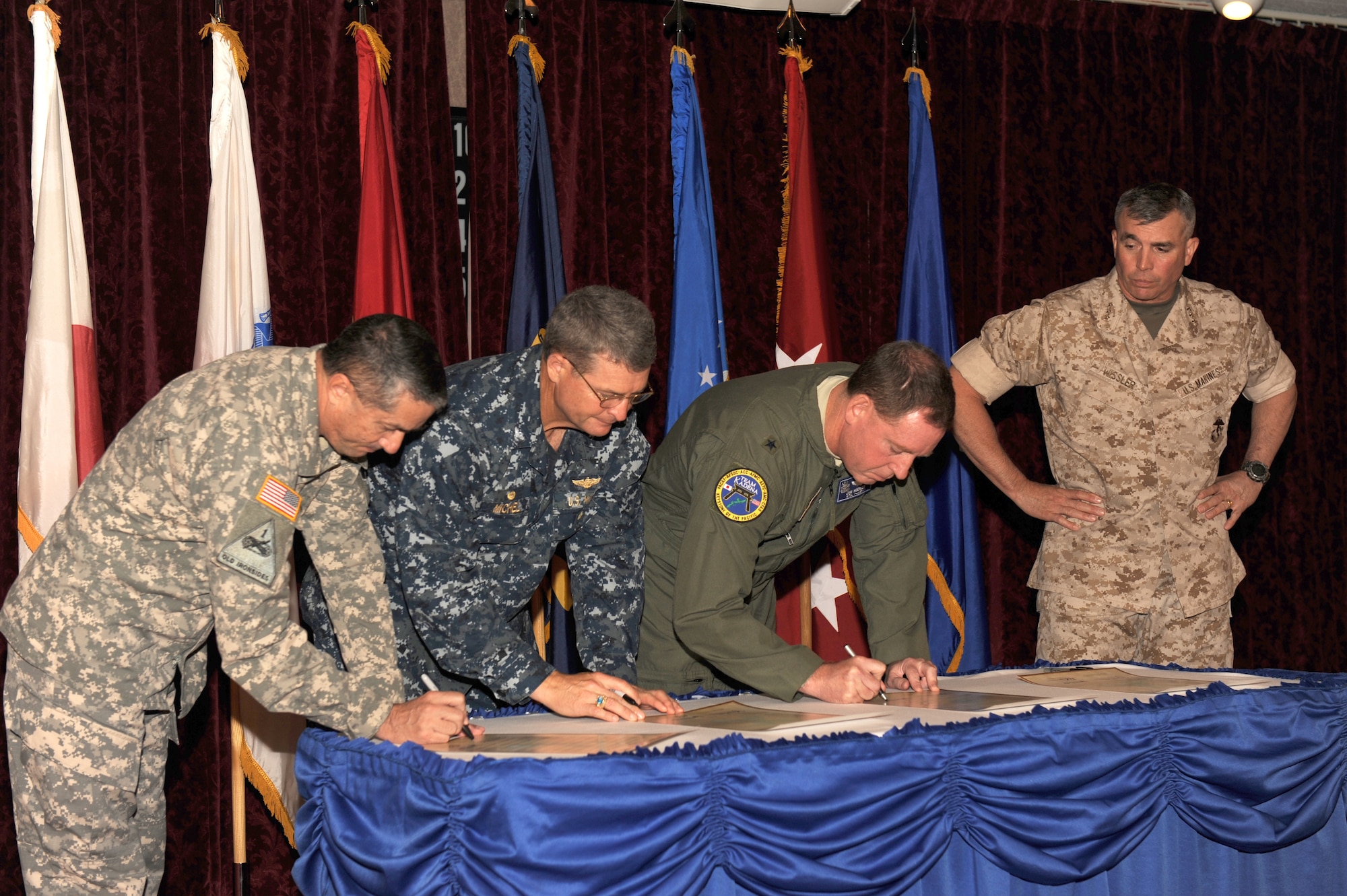 From left to right: U.S.Army Maj. Myron Temkin, 10th Regional Support Group chaplain; U.S. Navy Capt. Michael D. Michel, commanding officer of fleet activities; U.S. Air Force Brig. Gen. James B. Hecker, 18th Wing commander; U.S. Marine Corps Lt. Gen. John E. Wissler, 3rd Marine Expeditionary Force commanding general and Marine Forces Japan commander; sign a proclamation to show their support of the Sexual Assault Prevention and Response program at the Rocker NCO Club on Kadena Air Base, Japan, April 1, 2014. The proclamation officially declared April 2014 as Sexual Assault Awareness Month, and outlined what the SAPR program is and what it looks for. (U.S. Air Force photo by Airman 1st Class Zackary Henry)
