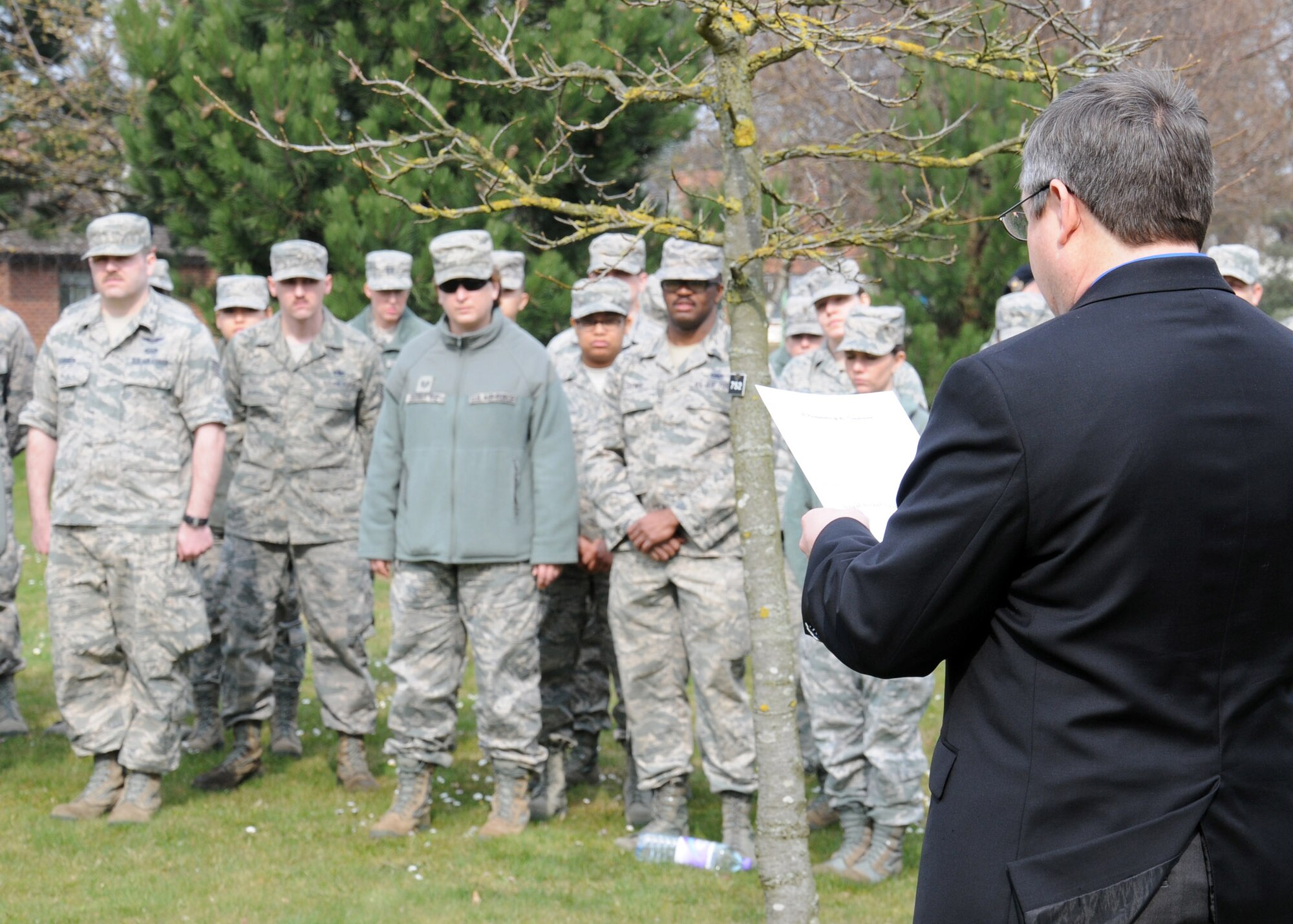 David Spencer, right, 100th Air Refueling Wing Sexual Assault Prevention and Response coordinator, reads a proclamation to kick off Sexual Assault Awareness Month prior to a ceremonial tree-planting March 28, 2014, on RAF Mildenhall, England. Team Mildenhall victim advocates met to discuss the way forward and to plant a tree dedicated to Team Mildenhall survivors of sexual assault. U.S. Air Force Col. Kenneth T. Bibb, Jr., 100th ARW commander, planted the tree. (U.S. Air Force photo by Gina Randall/Released)