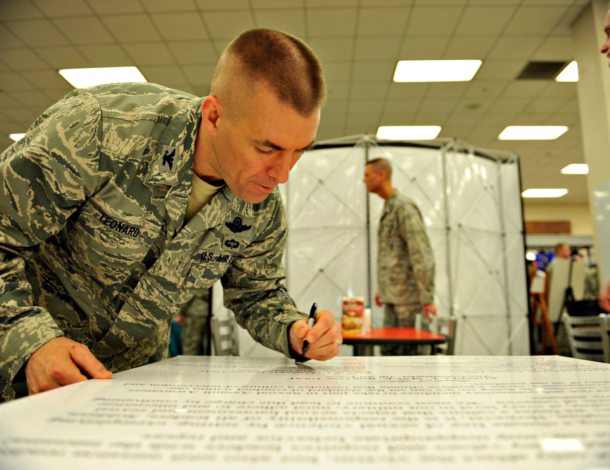 Col. Brook Leonard, 51st Fighter Wing commander, signs Team Osan’s National Sexual Assault Awareness Month proclamation at Osan Air Base, Republic of Korea, April 2, 2014. The proclamation serves as Team Osan’s declaration of eradicating sexual assault and harassment in the military community. (U.S. Air Force photo/Senior Airman Siuta B. Ika)