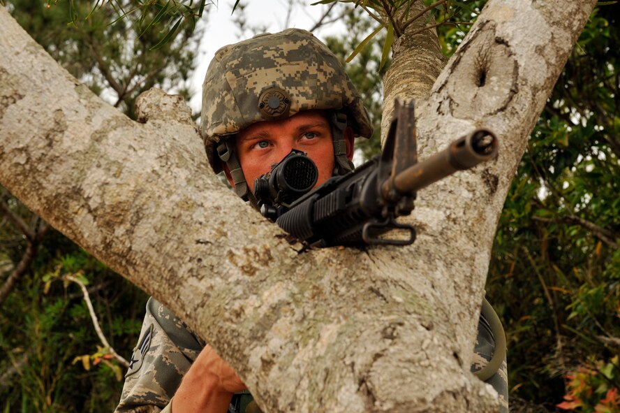 U.S. Air Force Senior Airman Trevor Huhns, 18th Logistics Readiness Squadron fuels controller, secures a landing zone during the U.S. Marine Corps 9th Engineer Support Battalion, Bulk Fuels Company, 1st Platoon Field Exercise on Camp Hansen, Japan, March 27, 2014. The training was conducted at designated areas within the central training area to prepare the Airmen for missions in support of the 3rd Marine Logistics Group and compete required annual training. (U.S. Air Force photo by Naoto Anazawa)
