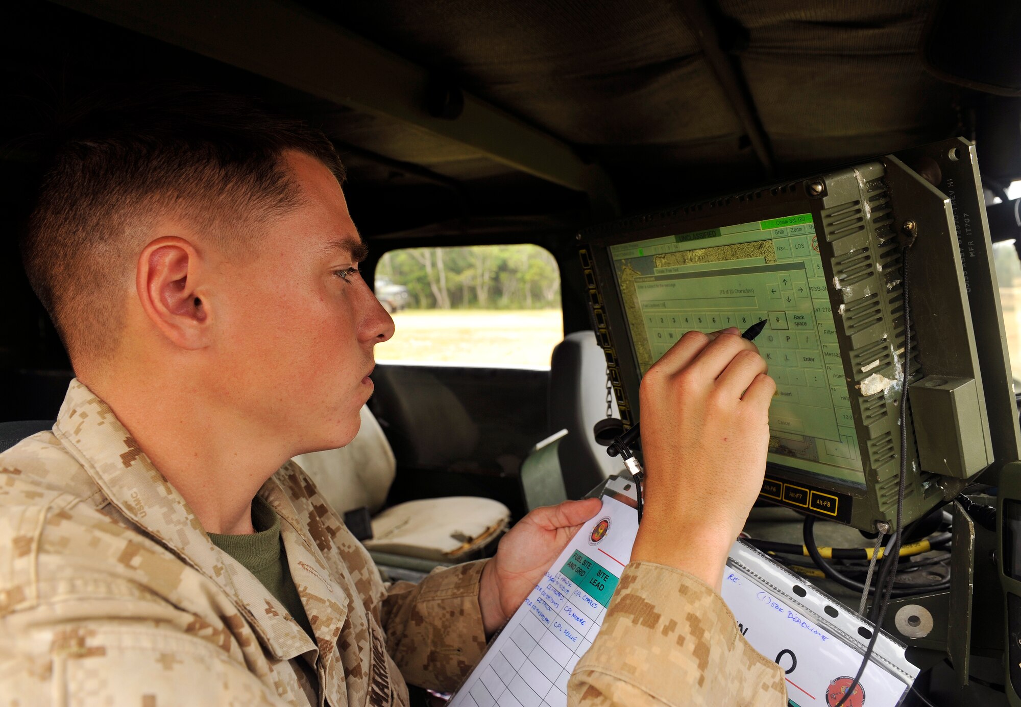 U.S. Marine Corps Lance Cpl. Ronald Duehring, 9th Engineer Support Battalion bulk fuels technician, inputs data into the Blue Force Tracker during the USMC 9th ESB, Bulk Fuels Company, 1st Platoon Field Exercise on Camp Hansen, Japan, March 27, 2014. The exercise provided the platoon an opportunity to conduct field training in a realistic environment to ensure proficiency in essential tasks. (U.S. Air Force photo by Naoto Anazawa)