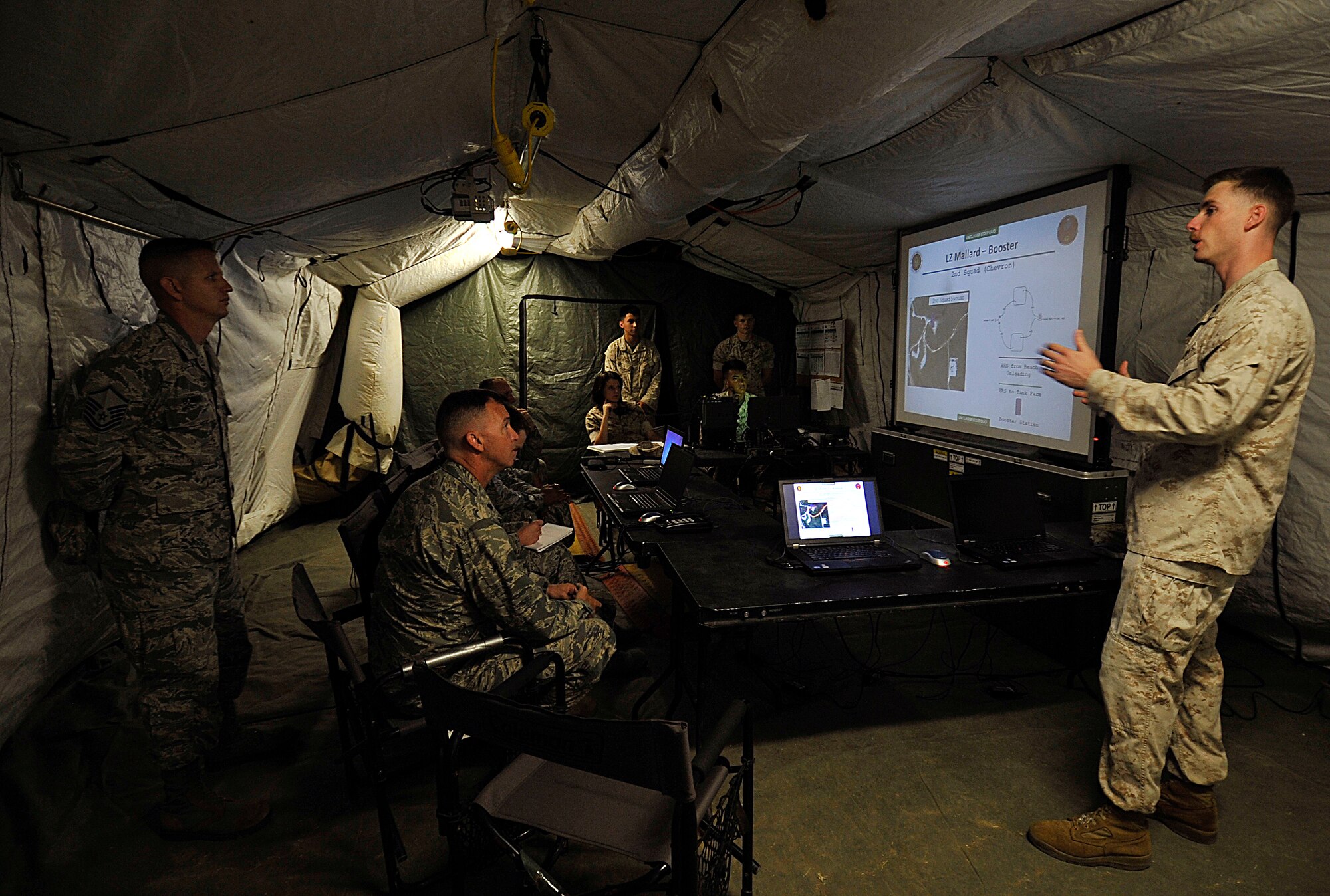 U.S. Marine Corps Capt. Kyle McCarley, 9th Engineer Support Battalion company commander, briefs about contents of the exercise during the USMC 9th ESB, Bulk Fuels Company, 1st Platoon Field Exercise on Camp Hansen, Japan, March 27, 2014. Three Airmen trained with more than 40 Marines around the clock in order to gain experience with various fuel systems in the employment of bare-based operations. (U.S. Air Force photo by Naoto Anazawa)